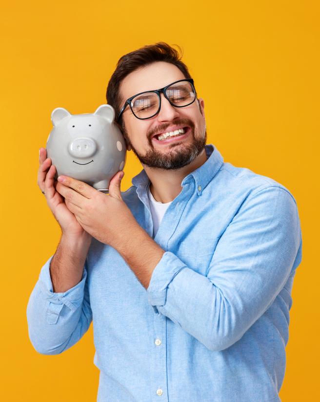happy man holding piggy bank