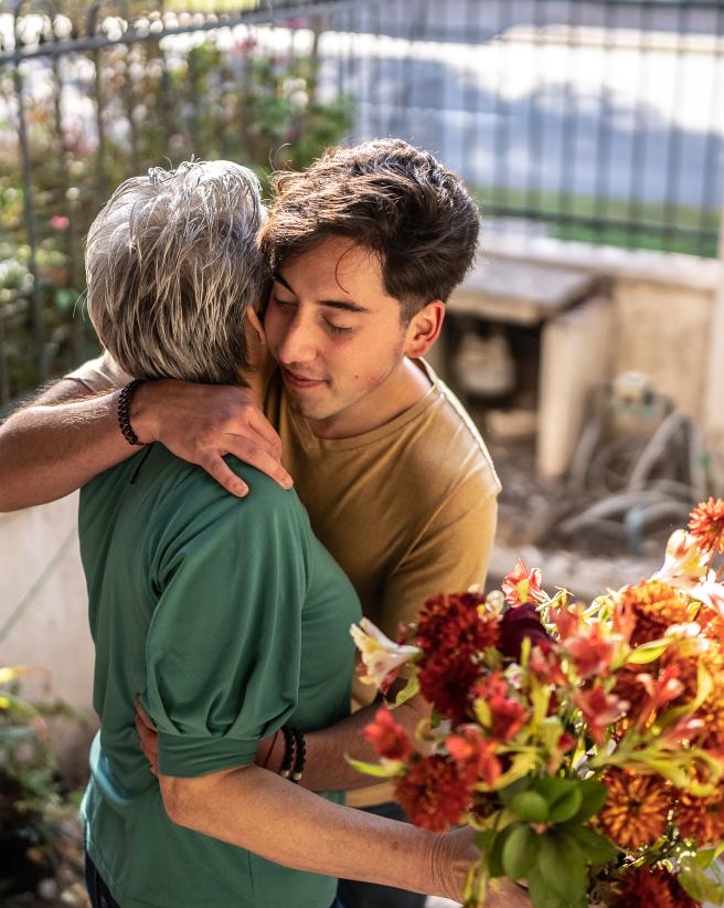 Family embracing with flowers.