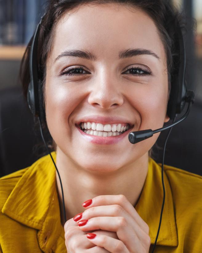 Helpful woman with a headset giving support.