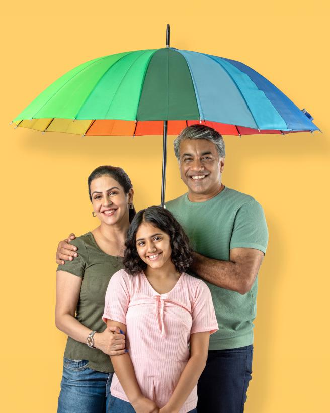 Parents and daughter with umbrella.