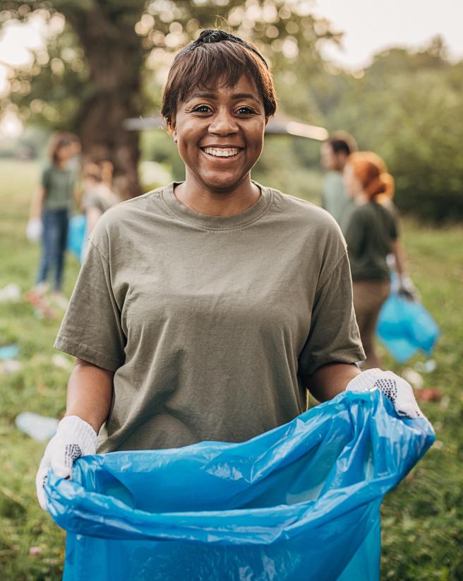 Volunteer working to clean up a park.