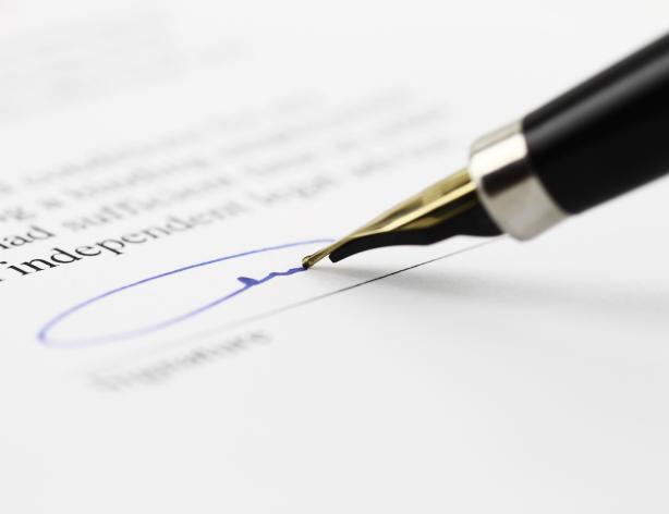 Pen with calligraphy nib signing a document