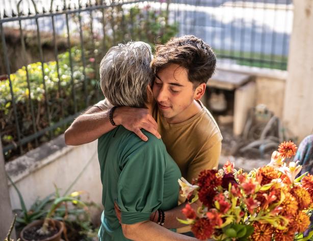 Family embracing with flowers.