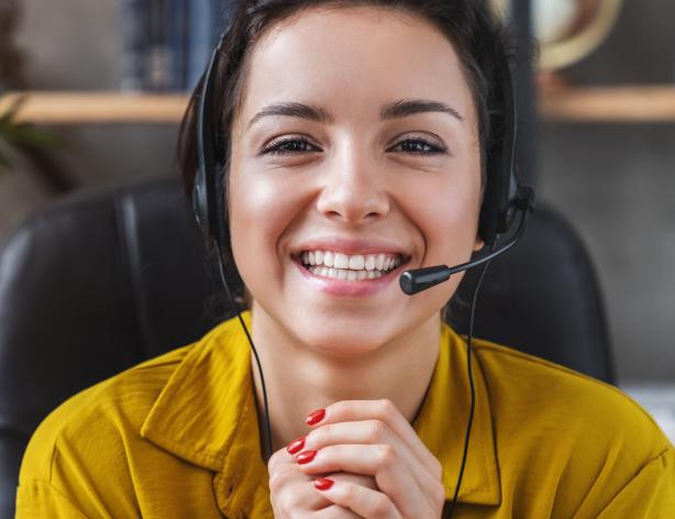 Helpful woman with a headset giving support.