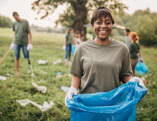Volunteer working to clean up a park.